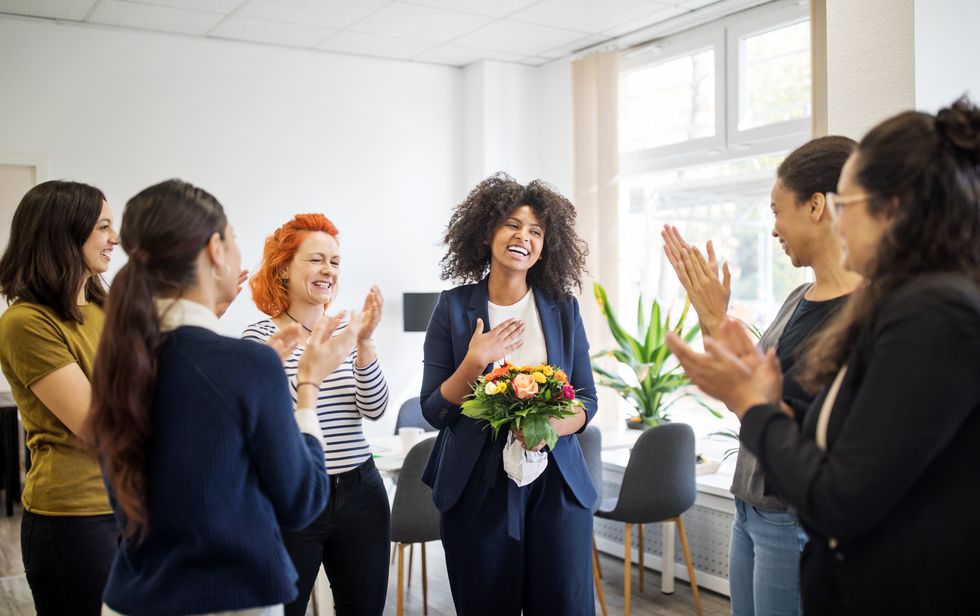 businesswomen celebrating an achievement of a colleague