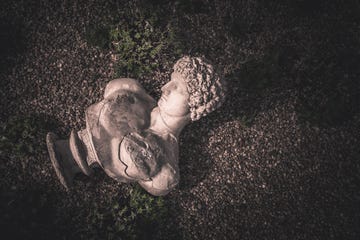 bust of ancient man on ground, high angle view