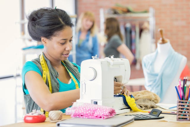 busy mid adult female tailor