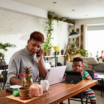 Busy working mother making phone calls from home