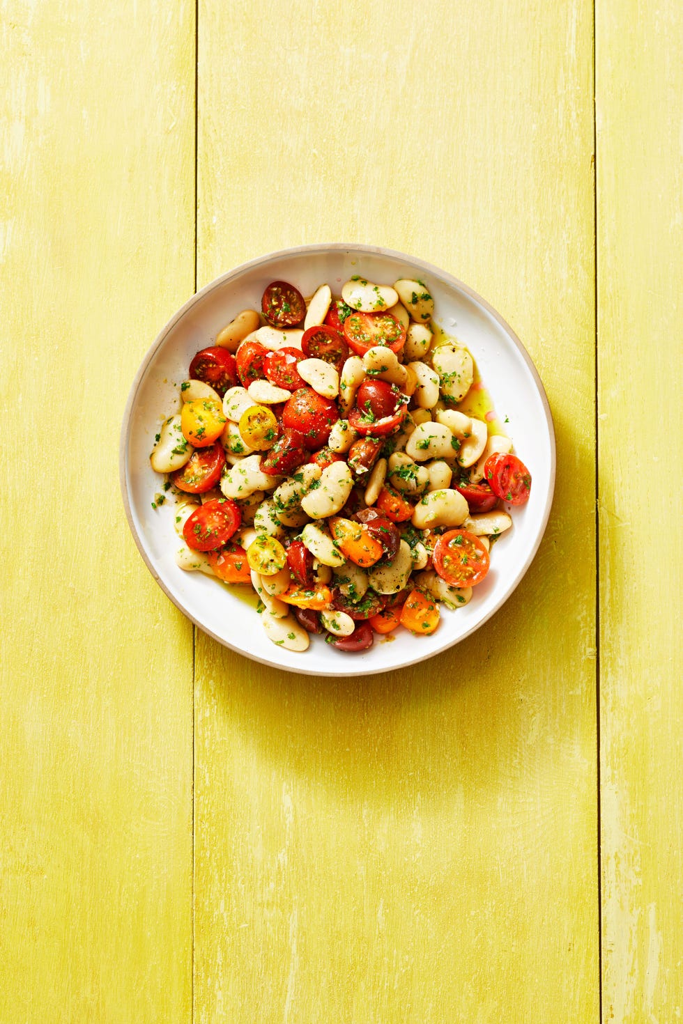 butter bean salad with herby vinaigrette on a white plate