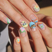 two hands with butterfly nail designs, the one on the left with neutral nails and red butterflies and the one on the right with pastel abstract art and butterflies