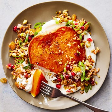 butternut squash steaks with creamy yogurt and farro and pomegranates on a plate