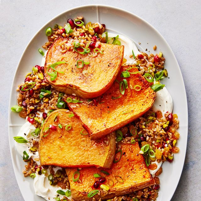 butternut squash steaks with creamy yogurt and farro and pomegranates on a plate