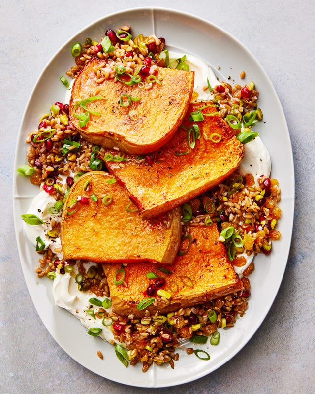 butternut squash steaks with creamy yogurt and farro and pomegranates on a plate