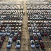 aerial shot of new cars lineup up in the port for import and export