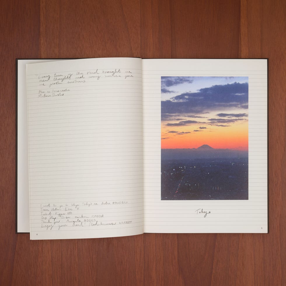 a book open with a picture of a beach and mountains in the background