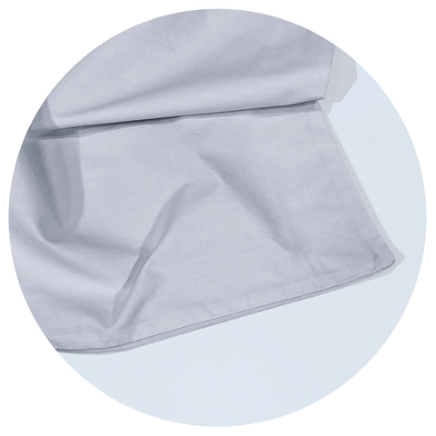 byub sheets close up in a white circular graphic frame