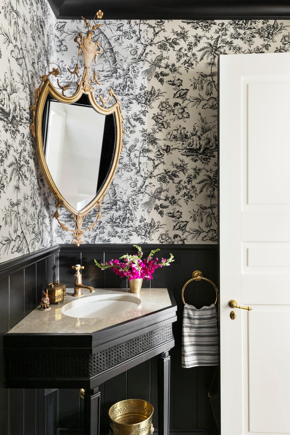 powder room designed by designer alexandra kaehler black and white wallpaper by pierre frey and beadboard painted in black by benjamin moore