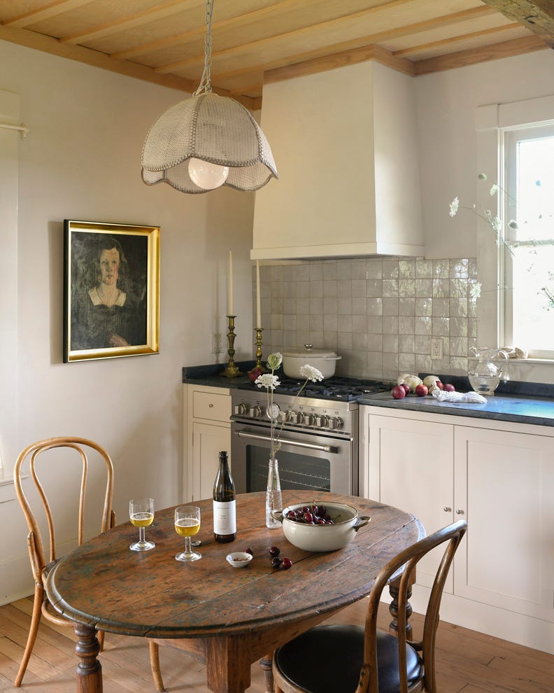 this modest kitchen designed by liz dutton interiors didn have enough space for a full island instead\, the team opted for a small table it provides extra space to make meals without hulking over the cooking zone