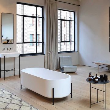 Monochrome bathroom, white sanitary-ware on black frames with oak floor