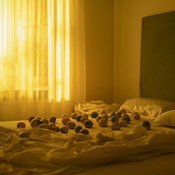 a bed with a white sheet and pillows