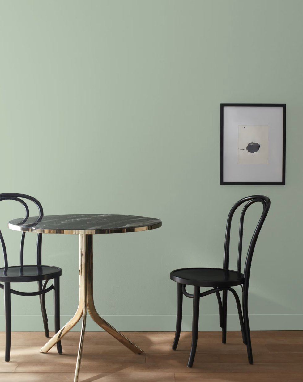 Dining area with a circular table and two chairs