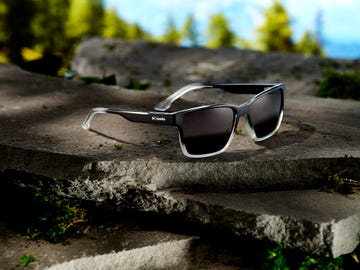 a pair of sunglasses on a stone surface