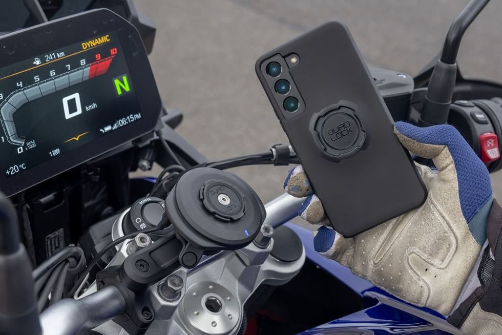 motorcyclist using a quadlock to mount his smartphone on his bike