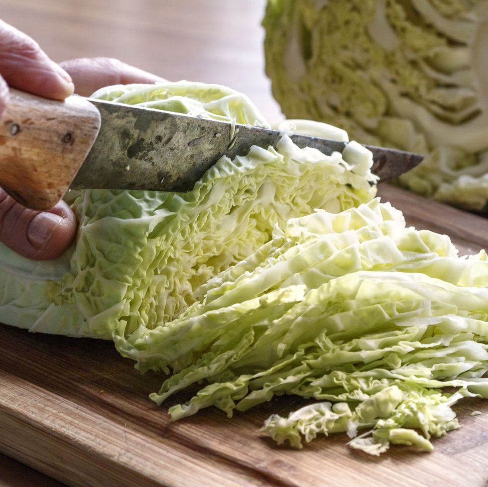 cabbage being sliced with old knife