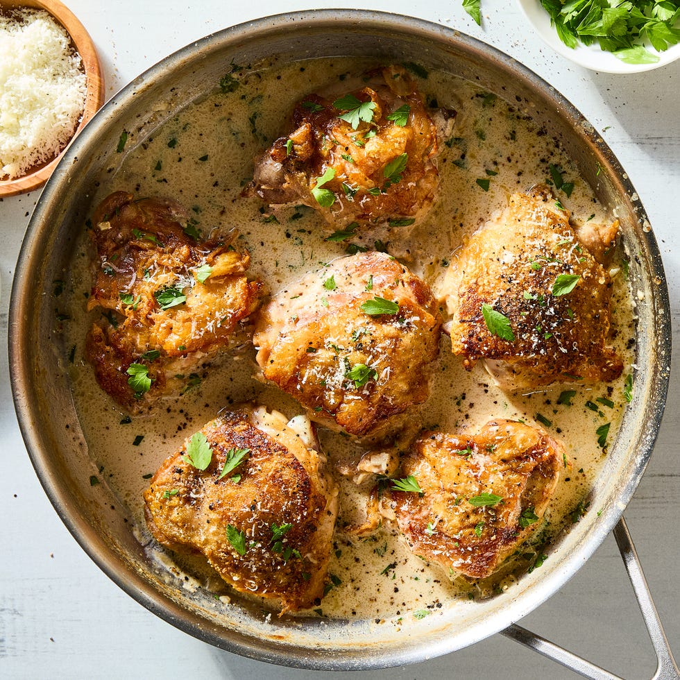 cacio e pepe chicken thighs with lemon wedges