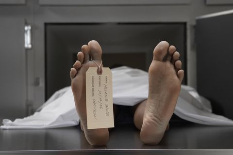 cadaver on autopsy table, label tied to toe