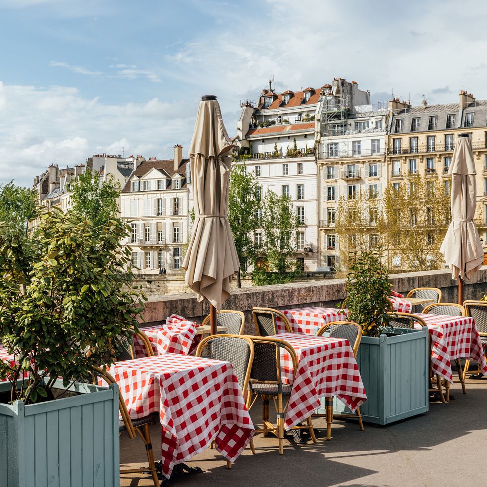 cafe on the bank of seine river on a sunny day, paris, france