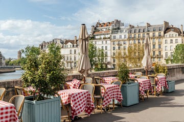 cafe on the bank of seine river on a sunny day, paris, france