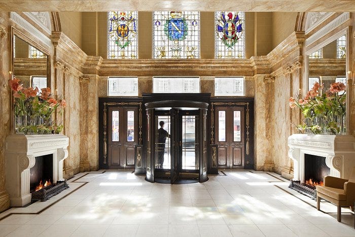 elegant hotel lobby with marble decor and a revolving door