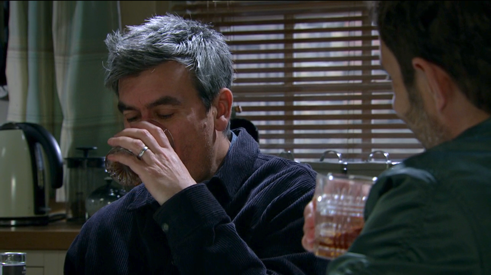 cain dingle drinks a glass of scotch with john sugden, emmerdale