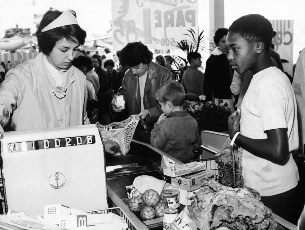 vintage photos of grocery store   customer checking out at cash register
