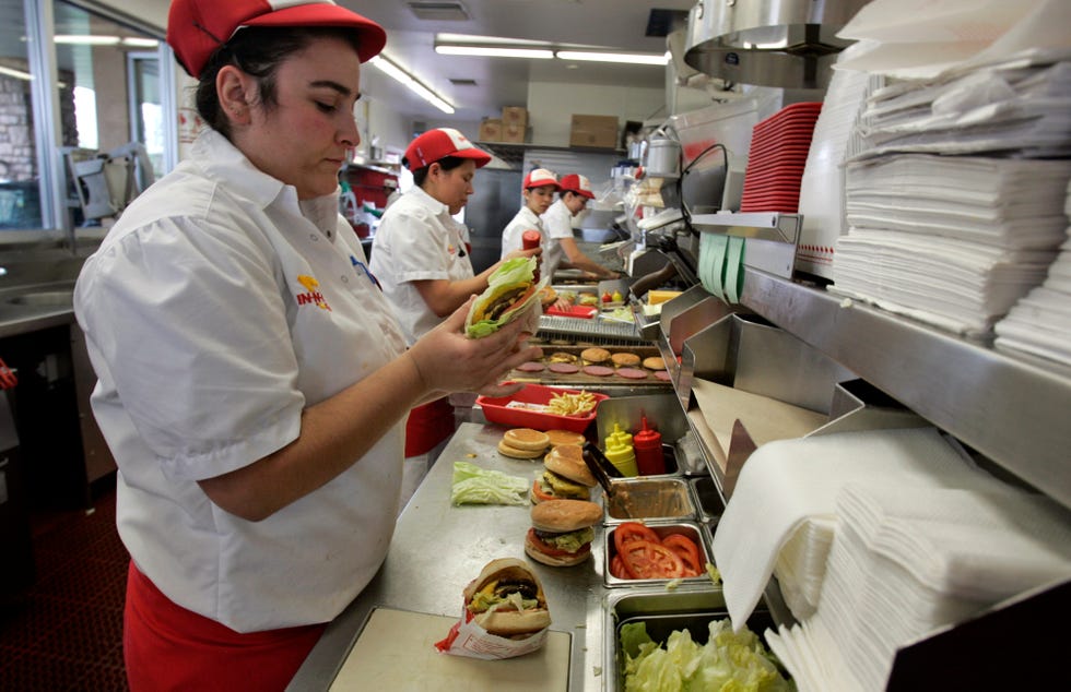 caitlin pogue cq prepares burgers for lunch customers at in n out in san marcos on february 06, 2