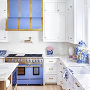 white kitchen with periwinkle range and hood