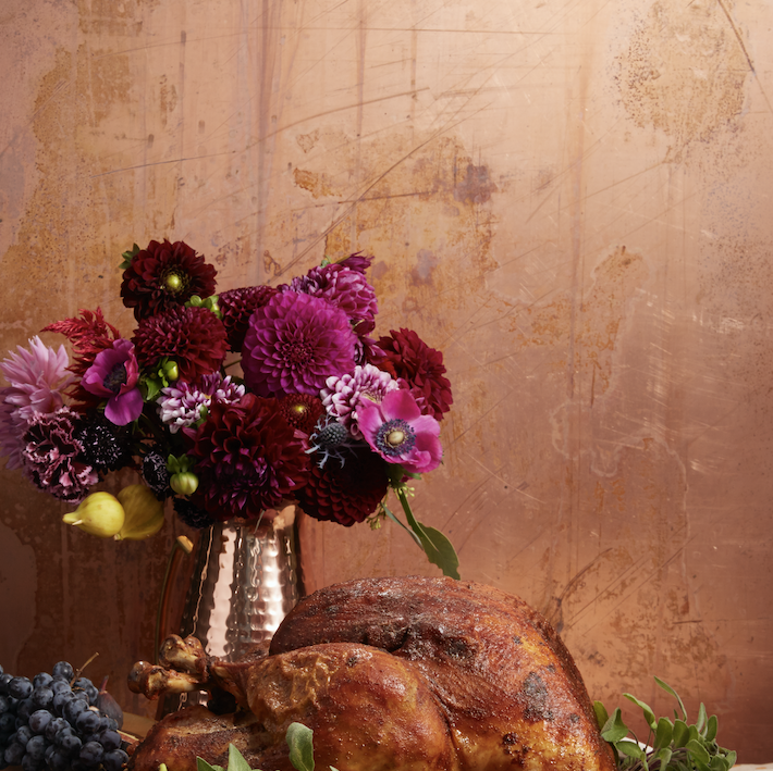 cajun spiced turkey on a platter with grapes and figs
