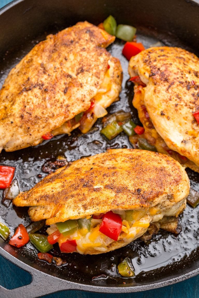 three cajun stuffed chicken breasts in a black cast iron pan