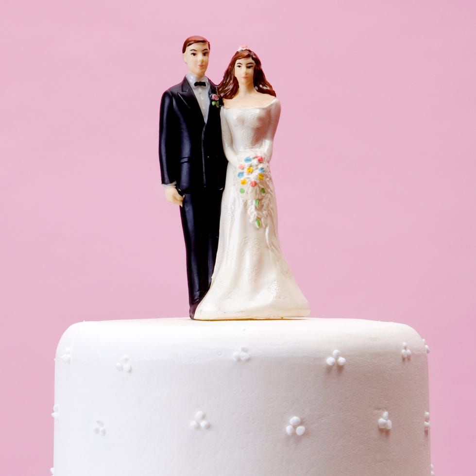 bride and groom wedding topper on a white wedding cake