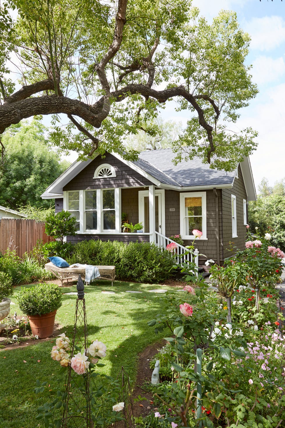 small gray craftsman bungalow with white trim