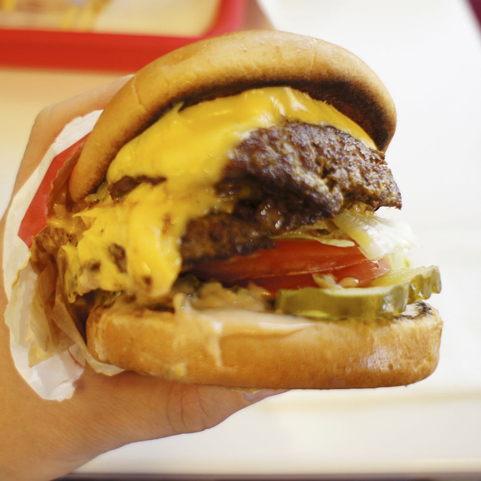 USA, California, Redondo Beach, Hand holding hamburger