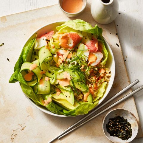 california roll salad with cucumber ribbons in a white bowl