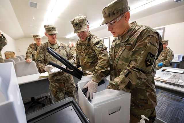 members of california’s heritage emergency response team practice packing and preserving wet documents during an exercise at camp san luis obispo in fall 2022