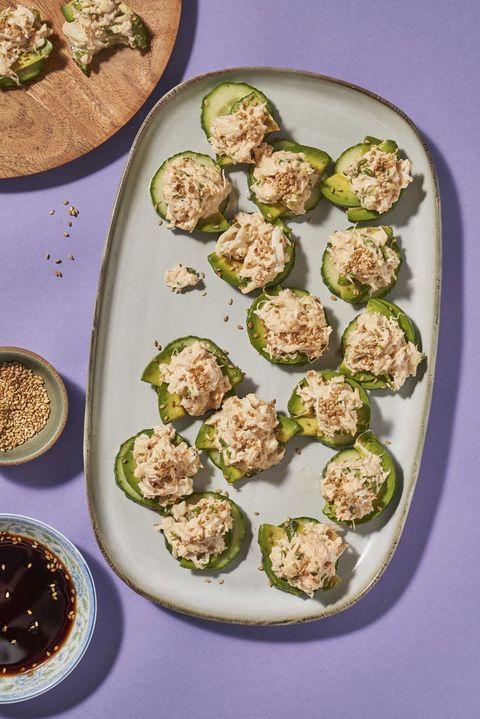cucumber sushi bites on an oven plate on a purple background