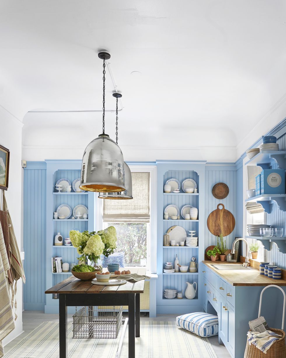 blue and white kitchen with sky colored open shelving, cabinetry, and beadboard accent walls