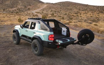 offroad vehicle parked in a desert landscape with an open tailgate