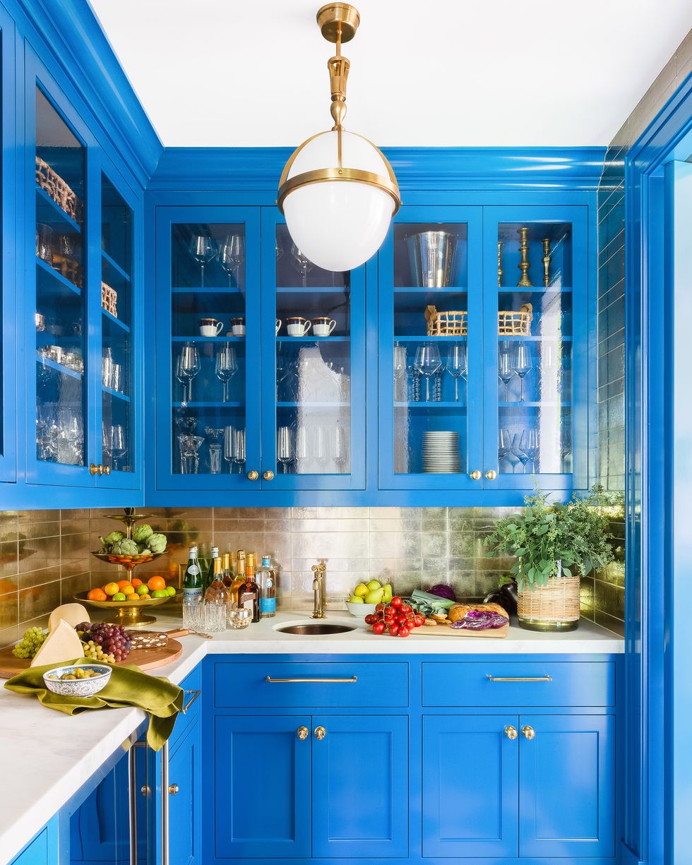 front view of a modern blue kitchen with pots and accessories