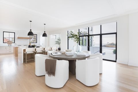 wood dining table, white chairs, coffee table books