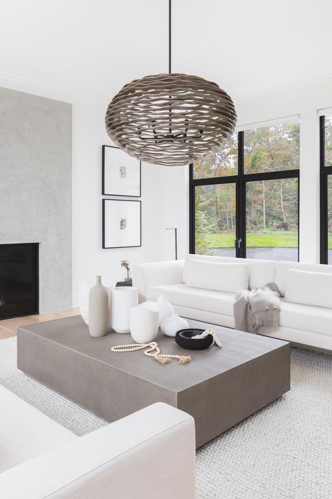 white couches, grey rug, coffee table, fireplace