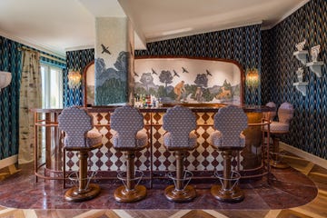 a bar with purple chairs