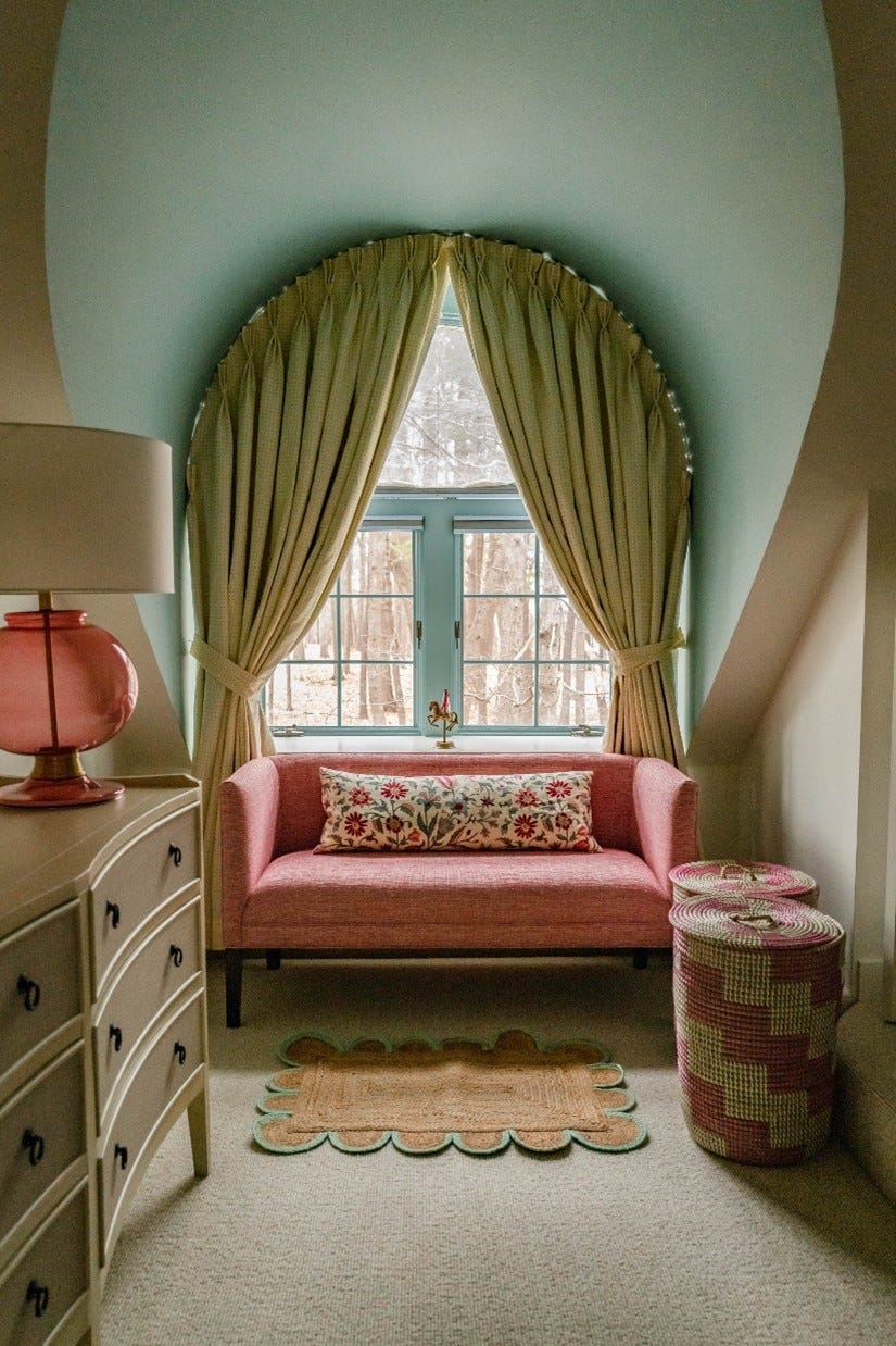 room with pink sofa and mint green walls