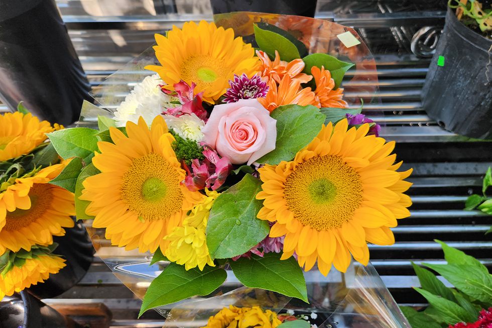 colorful bouquet of flowers with sunflowers and roses taken on the fold4