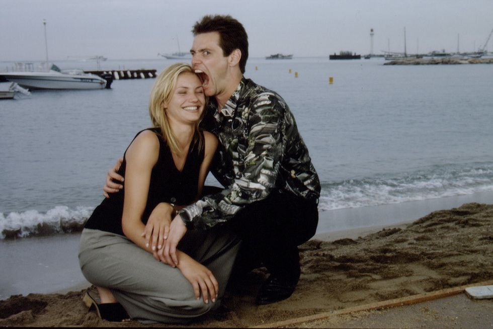 cameron diaz and jim carrey pose for a photo on a beach