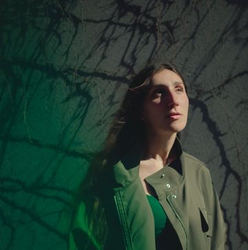 a woman in a green jacket