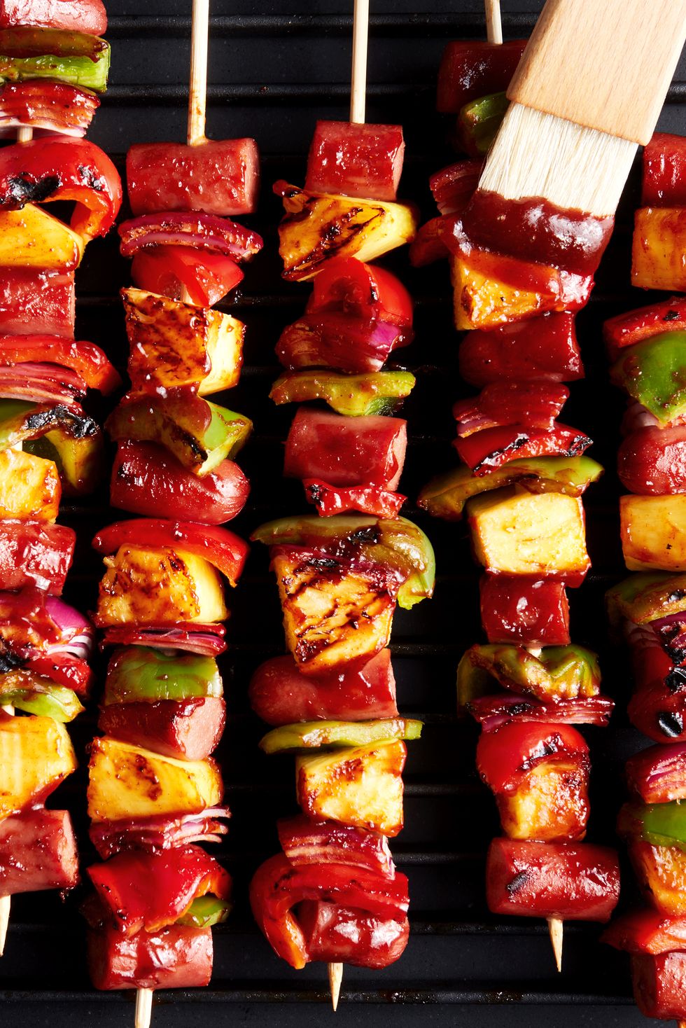 grilled skewers with sliced hot dogs, pineapple, red bell peppers basted with a bbq sauce