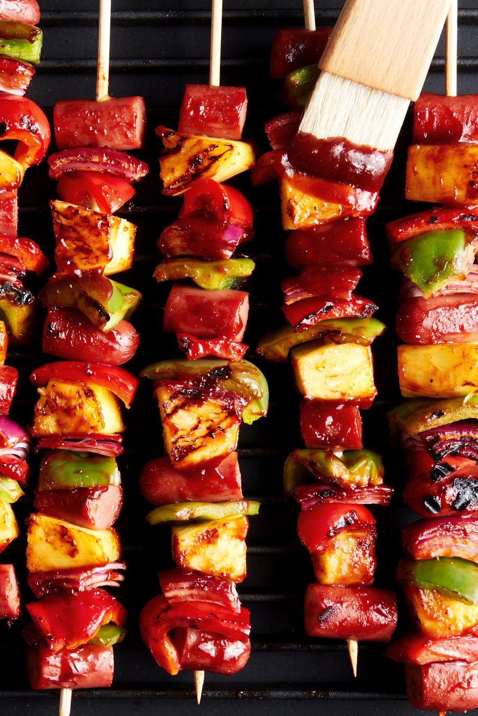 grilled skewers with sliced hot dogs, pineapple, red bell peppers basted with a bbq sauce