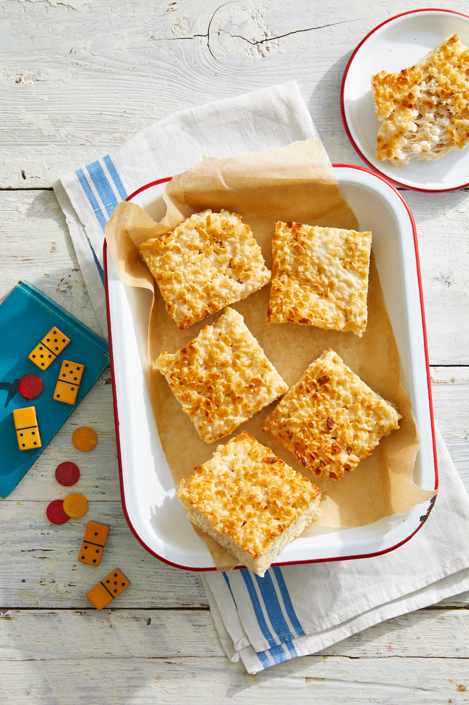 caramelized rice krispie treats in an enamelware vessel lined with parchment